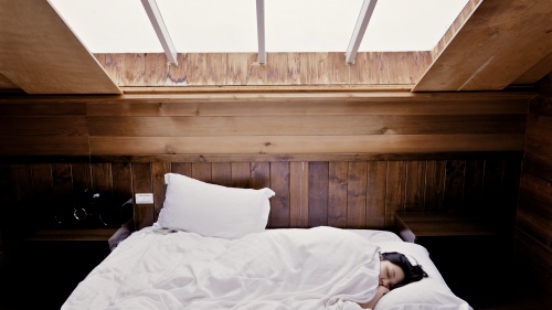 A person sleeping in a bed.