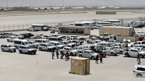 Afghan soldiers inspect some of the thousands of U.S. vehicles abandoned in the American pullout from Bagram Air Base, Afghanistan, in July 2021.