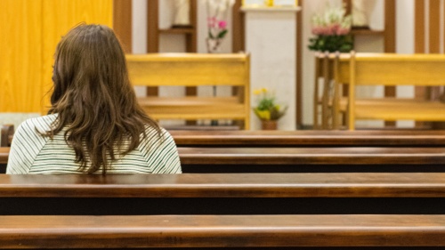 A woman sitting in a church.
